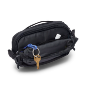 Cotopaxi Allpa X 1.5L Hip Pack - Cotopaxi Black side view of front zippered pocket