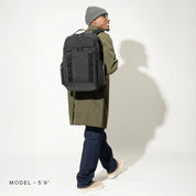 Travelpro Altitude™ Large Expandable Laptop Backpack 30-36L - Jet Black man with backpack over shoulder