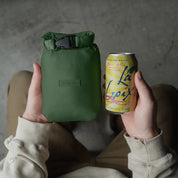 Square packable blanket,shown packed next to a can of soda