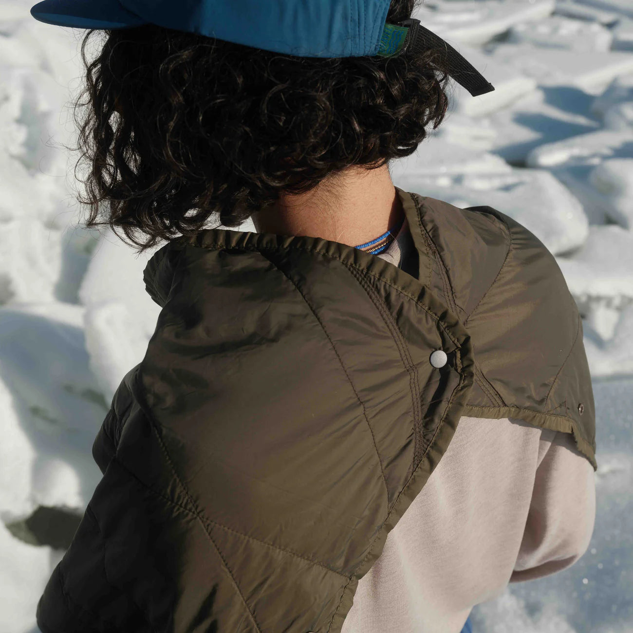 Square packable blanket, snapped view on person