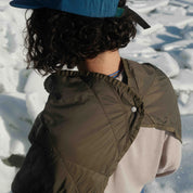 Square packable blanket, snapped view on person