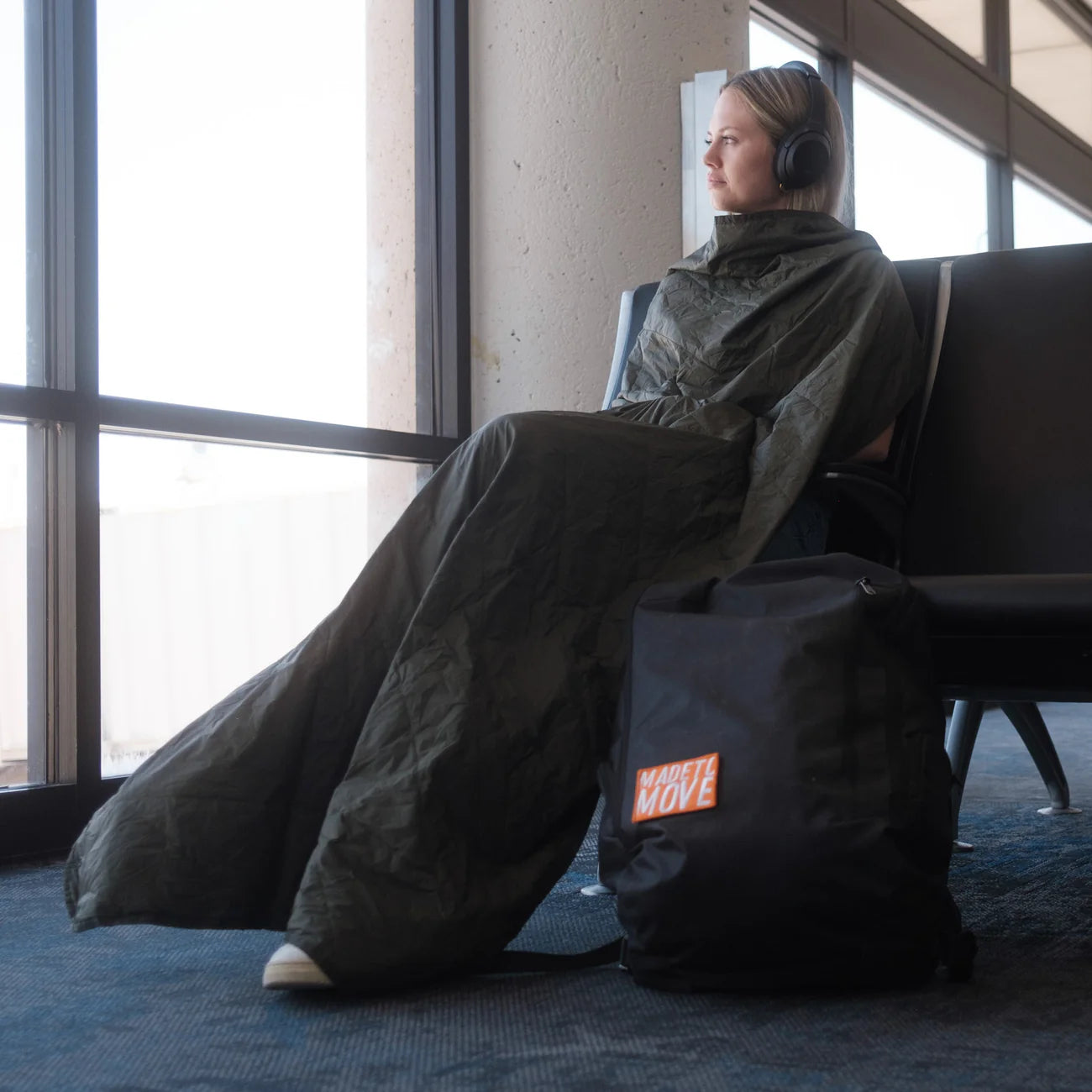 Square packable blanket,girl in airport covered with blanket