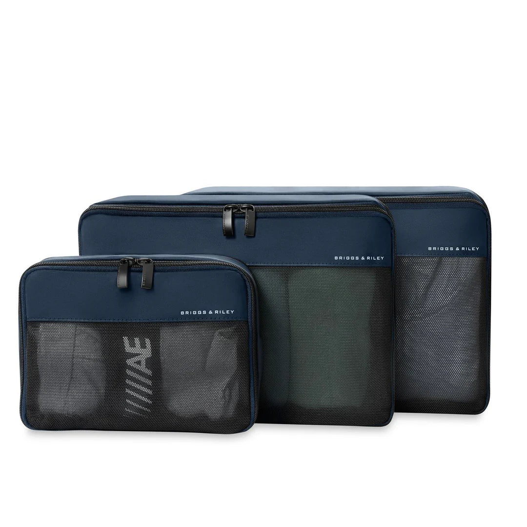 Three navy blue packing cubes with mesh pockets on a white background